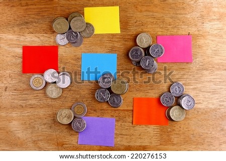 Different Stacks or piles of coins with colored paper tags Photo of different stacks or piles of coins with colored paper tags