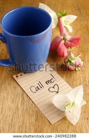 Coffee mug with lipstick mark and a note Photo of a Coffee mug with lipstick mark and a note saying call me
