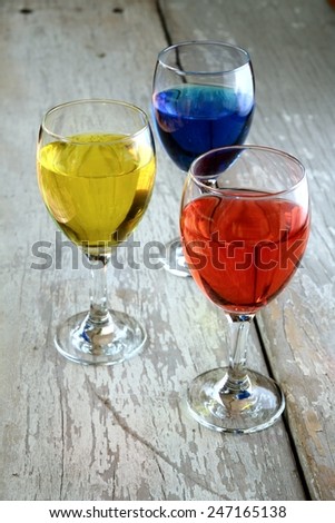 Colorful Drink in a goblet Photo of a Colorful Drink in a goblet on a wooden table