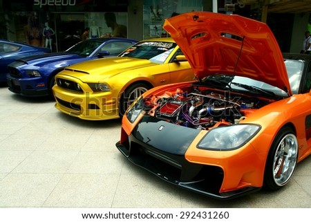 TAGUIG CITY, PHILIPPINES - JUNE 27, 2015: Expensive and customized luxury and race cars are displayed in a car show in Bonifacio Global City.