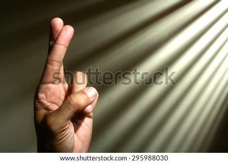 Hand crossing fingers