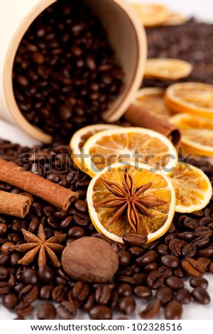 Coffee in a wooden barrel and spices: cinnamon, star anise and dried orange
