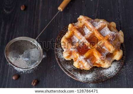 Waffles with honey and powdered sugar
