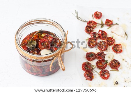 Dried cherry tomatoes with herbs and spices. Traditional Italian cuisine.