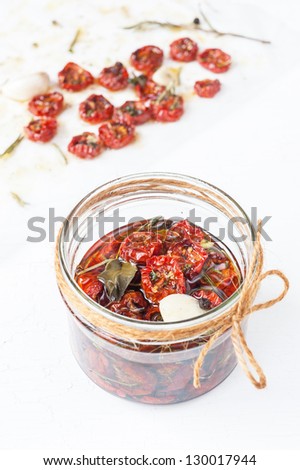 Dried cherry tomatoes with herbs and spices. Italian cuisine.