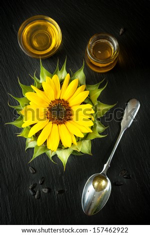 Sunflower oil, flower sunflower and seeds on the chalkboard