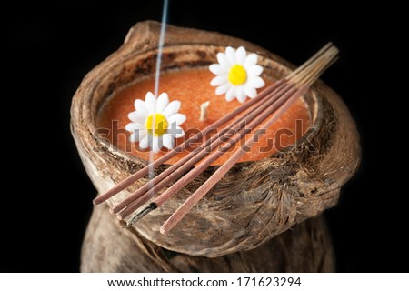 Aroma candle in coconut and incense sticks. The concept of meditation and relaxation