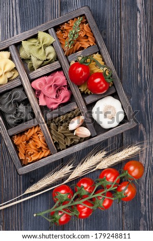 Various Italian pasta cherry tomatoes in vintage wooden box