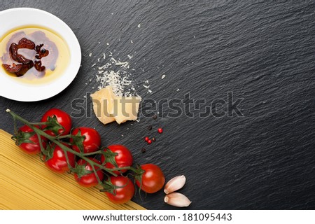 Italian food. Spaghetti,  tomatoes, cheese. Chalk board background.