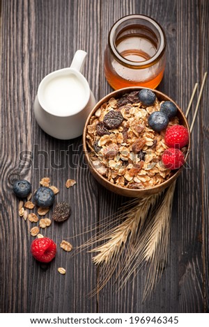 Granola muesli with honey, berries and milk