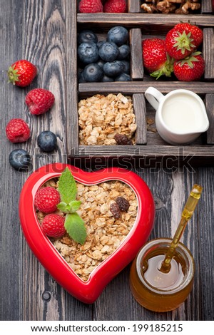 Granola muesli with berries, honey, nuts and milk. Healthy breakfast