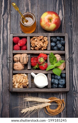 Granola muesli with berries, fruit, Ã?Â?Ã?Â  honey, nuts and milk. Concept of healthy food