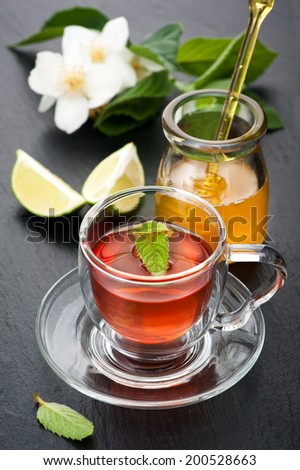 Herbal tea with mint, jasmine flowers and honey. Concept of health.