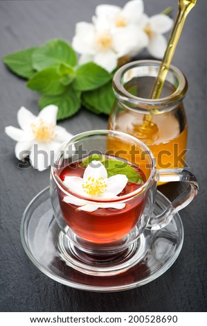 Herbal tea with mint, jasmine flowers and honey. Concept of health.