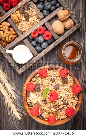 Muesli, berries, nuts, honey and milk. Healthy diet breakfast.