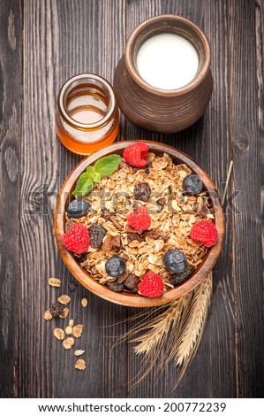 Muesli, berries, honey, milk. Healthy diet breakfast.
