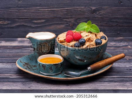Muesli, berries, milk and honey. Fitness Breakfast.