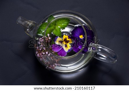 Herbal tea with flowers. Tea with mint, oregano and viola flowers.