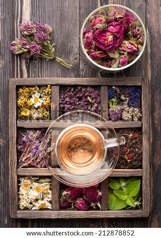 Dried Herbs and flowers in vintage box and herbal tea