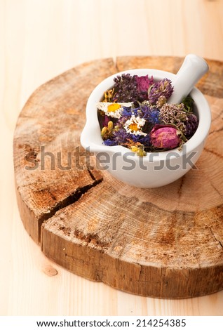 Dried flowers and herbs in mortar