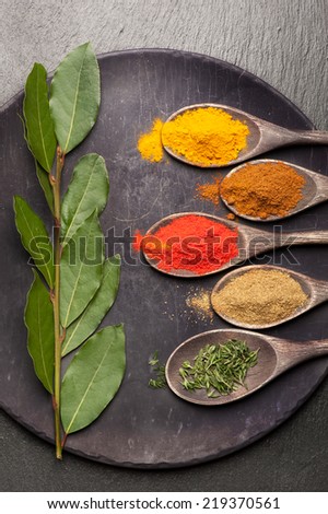 Spices, herbs and olive oil on vintage background. Food and cuisine ingredients.