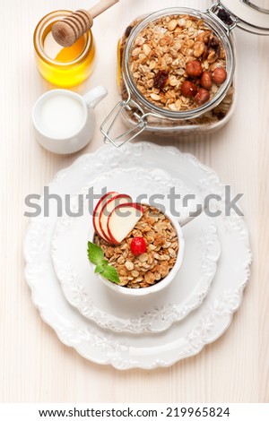 Granola with honey, fruits, nuts and milk. Healthy breakfast