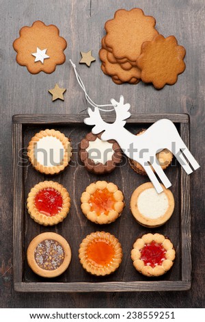 Cookies with chocolate and jam in wooden box and Christmas decorations