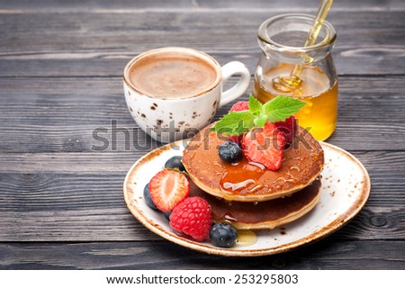 pancakes with honey, berries and coffee