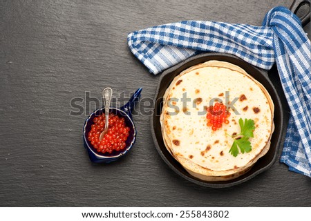 Pancakes with red caviar. top view