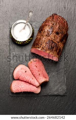 Roast beef on stone board. top view