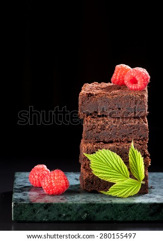 Chocolate cake brownies with raspberries