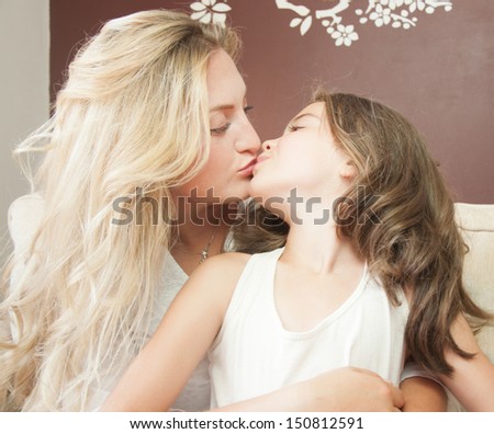 bright picture of kissing mother and daughter
