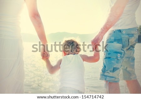 Happy family on the beach. Photo behind