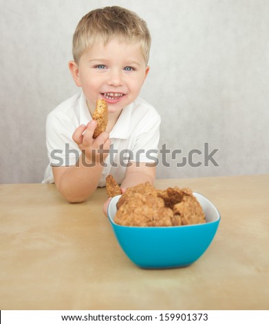 Cute  little boy eating cookies