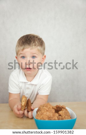 Cute  little boy eating cookies