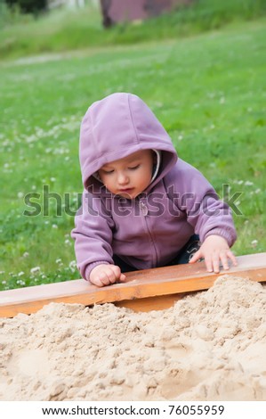 Little baby boy play in the sand box