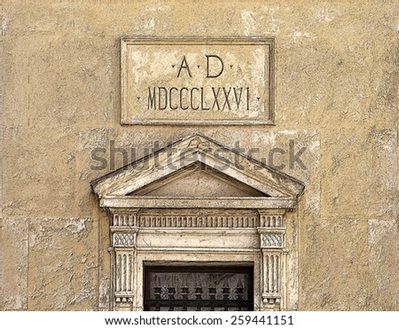 Historic doorway on stone building with the date in Roman numerals