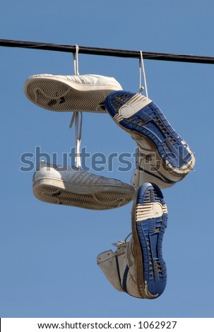 Sneakers hanging on a telephone line