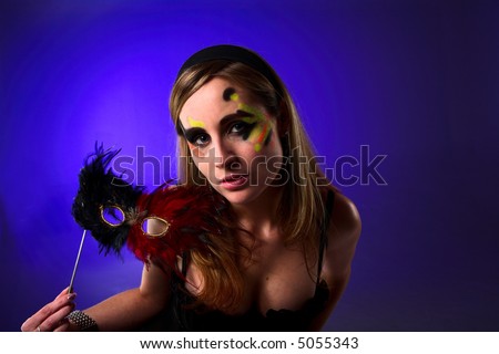 blond lady holding a mask at the ballroom dance