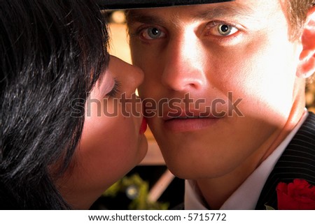 Two people in love, dancing, lady kisses her husband on the cheek