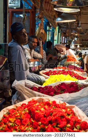 BANGALORE, INDIA - June 06: Flower seller at KR Market in Bangalore. June 06, 2014 in Bangalore, India.