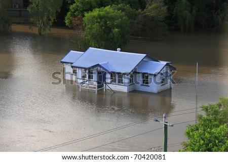 BRISBANE, QUEENSLAND/AUSTRALIA - JANUARY 13:Queenslander house stands alone in a flooded area on January 13, 2011 in Milton, Brisbane, Queensland, Australia.