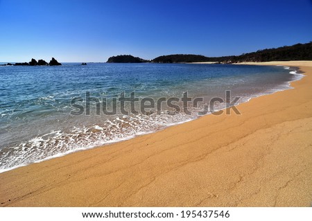 Secluded ocean bay with strikingly blue skies and amazing sand texture