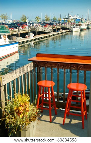 Two Empty Orange Bar Stools Overlooking Maine Harbor