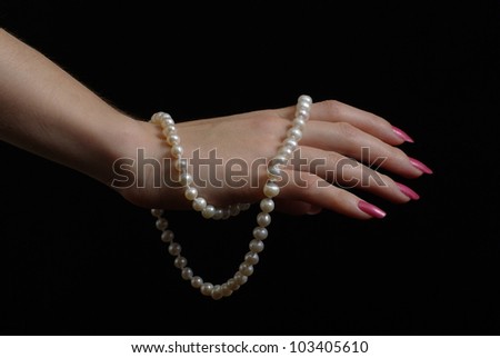 Female hand with pearl beads