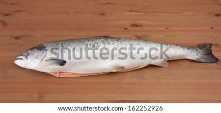 Gutted atlantic salmon on a wooden table