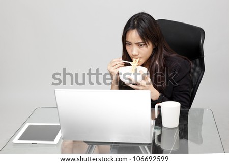 woman worker eating unhealthy food during the office hour.