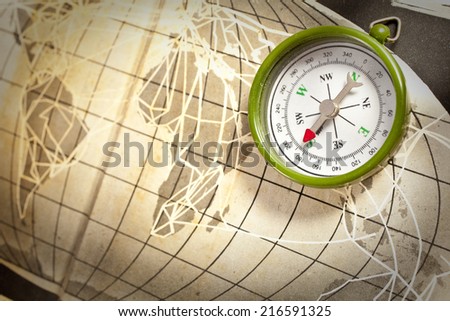 Magnetic compass old map conceptual of global travel , tourism and exploration