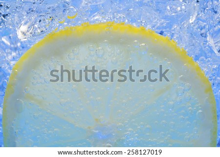 Lemon Slice in Fizzy Water Bubble Background with ice cube