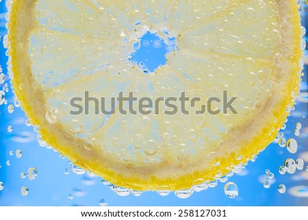 Lemon Slice in Fizzy Water Bubble Background